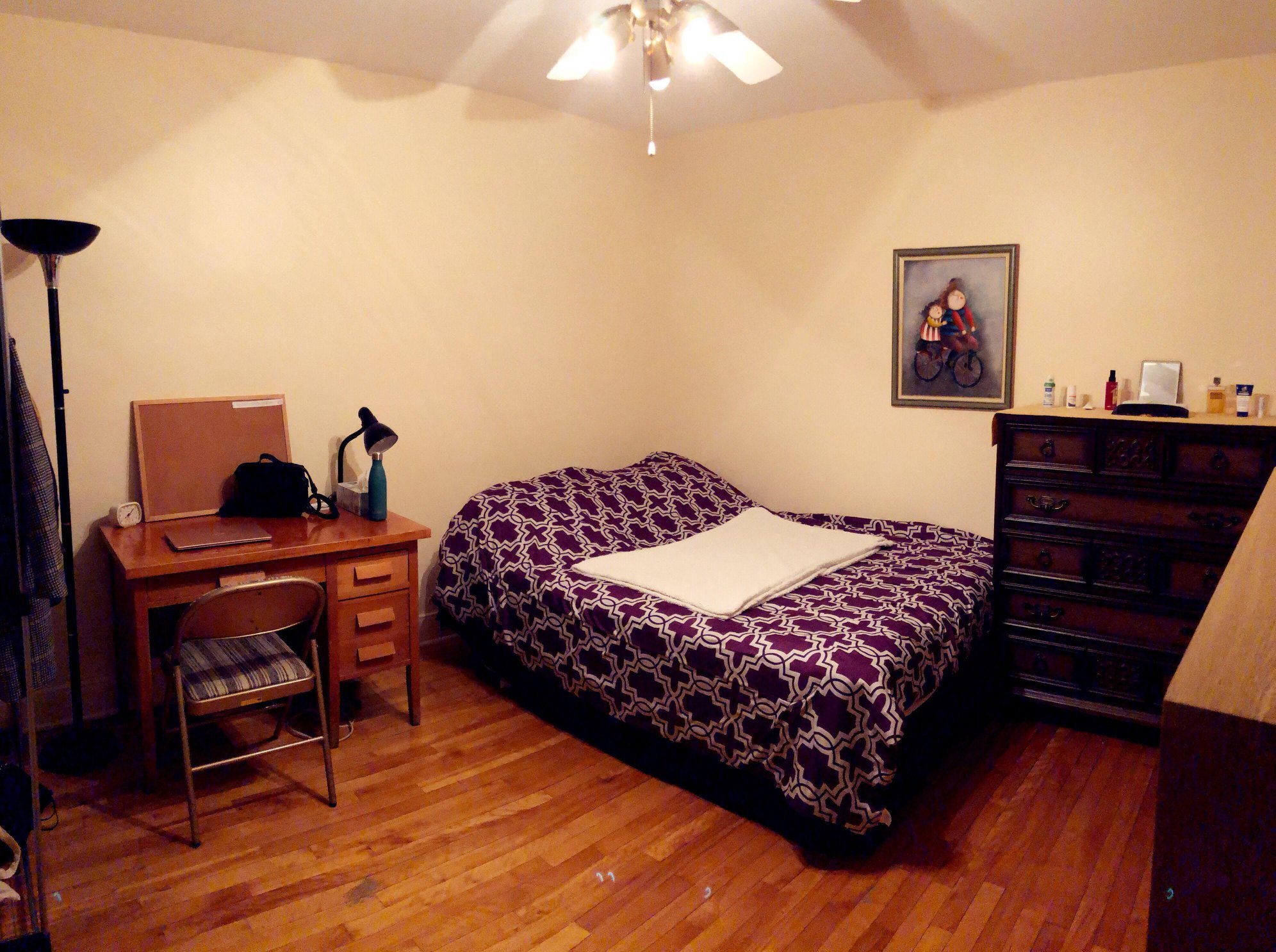 Private homestay bedroom with a bed and desk